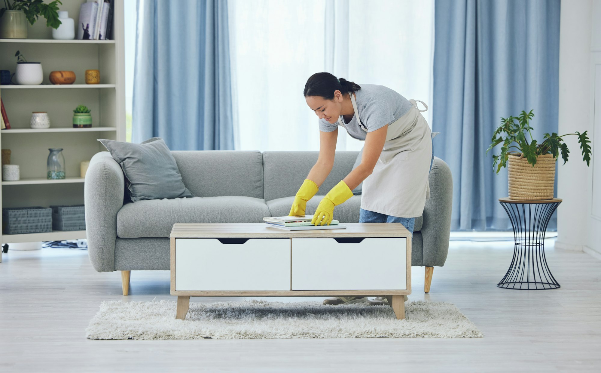 Cleaning is for weekends. Shot of a young woman cleaning at home.